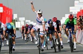 Tim Merlier raises his fist to celebrate a stage victory after two near misses in  the UAE Tour