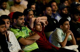 Death of a dream: Cricket fans in Karachi watch a live broadcast of the Champions Trophy match between India and Pakistan on a big screen