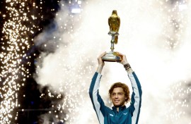 Andrey Rublev brandishes the trophy  after winning the Qatar Open