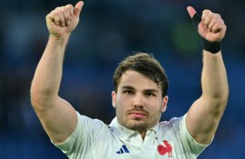 Twice as good: France scrum-half Antoine Dupont, who scored two tries, celebrates victory in Italy