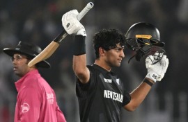 New Zealand’s Rachin Ravindra celebrates after reaching his century against Bangladesh