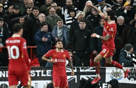 Title push: Liverpool midfielder Dominik Szoboszlai (R) celebrates scoring 