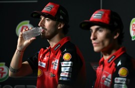 Francesco Bagnaia (L) and  Marc Marquez take part in a press conference in Thailand