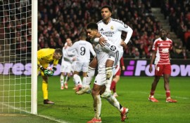 Real Madrid's English midfielder Jude Bellingham celebrates with teammate Rodrygo (top)