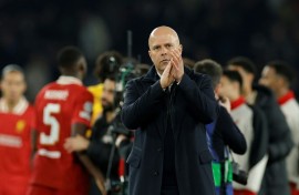 Arne Slot applauds fans after Liverpool's 1-0 win against Paris Saint-Germain in the first leg of their last-16 tie in the Champions League