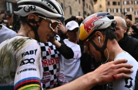 Tadej Pogacar (L) and Tom Pidcock greet each other at the end of the Strade Bianche