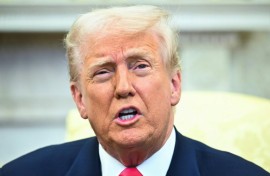 US President Donald Trump speaks to reporters as he meets with Irish Prime Minister Micheal Martin in the Oval Office of the White House in Washington, DC, on March 12, 2025. Looking on from the couch, L-R, are US Vice President JD Vance and White House Chief of Staff Susie Wiles. 