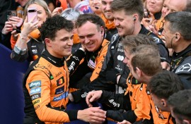 Lando Norris (left) celebrates with his McLaren team after winning the Australian Grand Prix