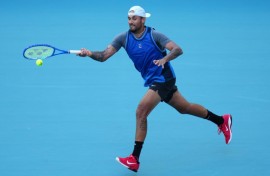 Nick Kyrgios returns a shot against Mackenzie McDonald en route to his first win since 2022