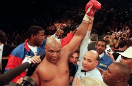 George Foreman raises his arm aloft after defeating Michael Moorer to recapture the heavyweight title in 1994