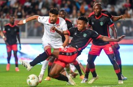 Tunisia forward Hazem Mastouri (L) is surrounded by Malawi defenders during a 2026 World Cup qualifier in Rades.