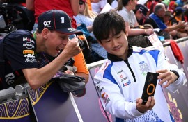 Man in demand: Yuki Tsunoda takes selfies with fans at the season-opening Australian Grand Prix