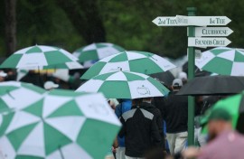 Spectators evacuate Augusta National Golf Club after bad weather halted the first official practice round for the 89th Masters