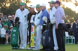 Honorary Starters Gary Player of South Africa and Americans Jack Nicklaus and Tom Watson of the United States pose with their caddies on the first tee after hitting honorary tee shots to start the 89th Masters