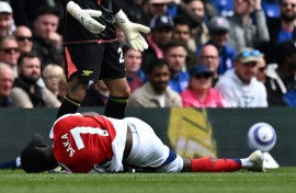 Arsenal's Bukayo Saka lies injured after Leif Davis's foul at Ipswich