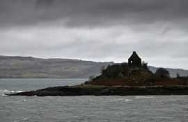 The Isle of Mull, pictured beyond a building in the foreground, across the Sound of Mull