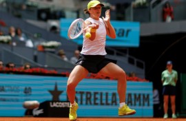 Iga Swiatek returns the ball during her Madrid Open quarter-final defeat of Madison Keys