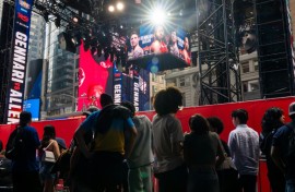 People gather around the outdoor boxing ring erected in Times Square for the fight card featuring Ryan Garcia's return from a doping suspension