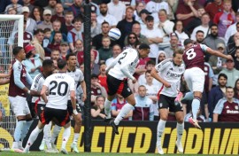 Aston Villa's Youri Tielemans (R) heads the winner against Fulham