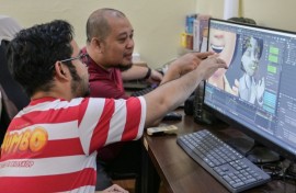 Ryan Adriandhy Halim (L), speaking with a computer illustrator in Jakarta