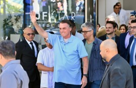Brazilian former president Jair Bolsonaro waves to supporters as he leaves hospital on May 4, 2025, three weeks after undergoing surgery to treat an intestinal obstruction