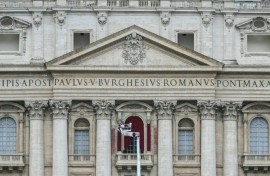 A worker prepares the main central balcony of St Peter's basilica