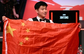 Zhao Xintong poses with the Chinese flag after winning the World Snooker Championship final