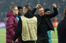 PSG coach Luis Enrique (R) celebrates his team's victory over Arsenal in Wednesday's Champions League semi-final