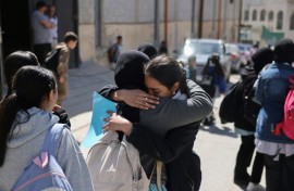 Palestinian schoolgirls leave a UNWRA school in the Shuafat refugee camp