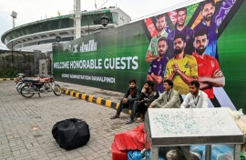 Vendors pack their belongings as they leave Rawalpindi Cricket Stadium following the postponement of Thursday's match in the PSL