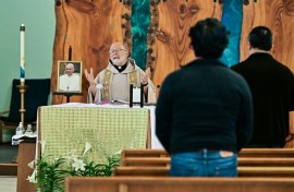 A portrait of the late pope Francis rests on the altar during a mass at St Camillus Catholic Church in Los Angeles, California, following the selection of American Robert Francis Prevost to be the new pontiff, Pope Leo XIV