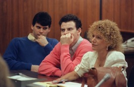 Erik Menendez (C) and his brother Lyle have been resentenced for the 1989 murders of their parents with a term that means they are now eligible to apply for parole