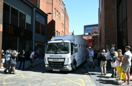 Members of the public and photographers look on as a prison van leaves from the back of a Manchester court shortly after US R&B singer Chris Brown charged with a 2023 assault in a London nightclub