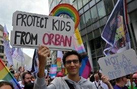 A protester holds a sign reading 'Protect the children from Orban' during a demonstration in Brussels, May 17, 2025.