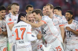 Bayern Munich's players congratulate Michael Olise after winning the league title.