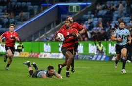 Canterbury Crusaders' Sevu Reece (C) runs the ball for a try during a Super Rugby match against the New South Wales' Waratahs in Sydney on May 16, 2025