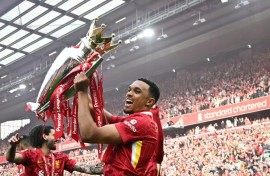 Liverpool's Trent Alexander-Arnold celebrates with the Premier League trophy