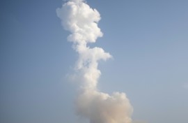 A plume of exhaust from the rocket boosters is left behind after the SpaceX Starship rocket launched from Starbase, Texas, as seen from South Padre Island on May 27, 2025