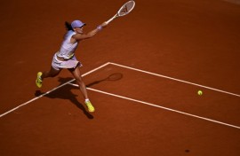 Poland's Iga Swiatek swept past Britain's Emma Raducanu in the second round to keep her bid for a fourth straight French Open title on track