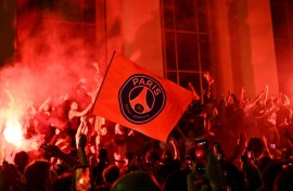 Jubilant Paris Saint-Germain supporters set off flares on Place Trocadero in front of the Eiffel Tower