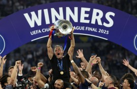 Paris Saint-Germain coach Luis Enrique lifts the Champions League trophy after his side outclassed Inter Milan in the final