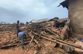 People picked through debris from damaged buildings in Mokwa