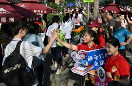 While teachers and staff offered students their support, holding up signs of encouragement, some test takers, dressed in school uniforms, appeared panicked