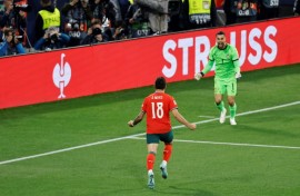 Ruben Neves runs toward Portugal's goalkeeper Diogo Costa after netting the winning penalty