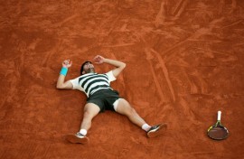 Carlos Alcaraz celebrates after an incredible French Open win over Jannik Sinner in five sets