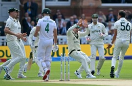 Australia's Mitchell Starc celebrates with Steve Smith (C) after dismissing South Africa's Aiden Markram