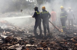 A huge plume of smoke rising from the crash site of the Air India plane
