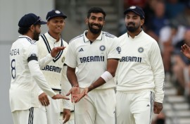 India's Jasprit Bumrah (C) celebrates with team-mates after dismissing England's Chris Woakes in the first Test at Headingley