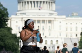 Extreme heat has scorched US cities like the capital Washington, where a woman on the National Mall is seen trying to stay comfortable in the summer weather