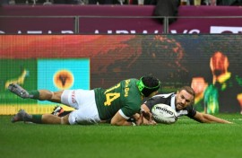 South Africa winger Cheslin Kolbe (L) scores against the Barbarians at Cape Town Stadium